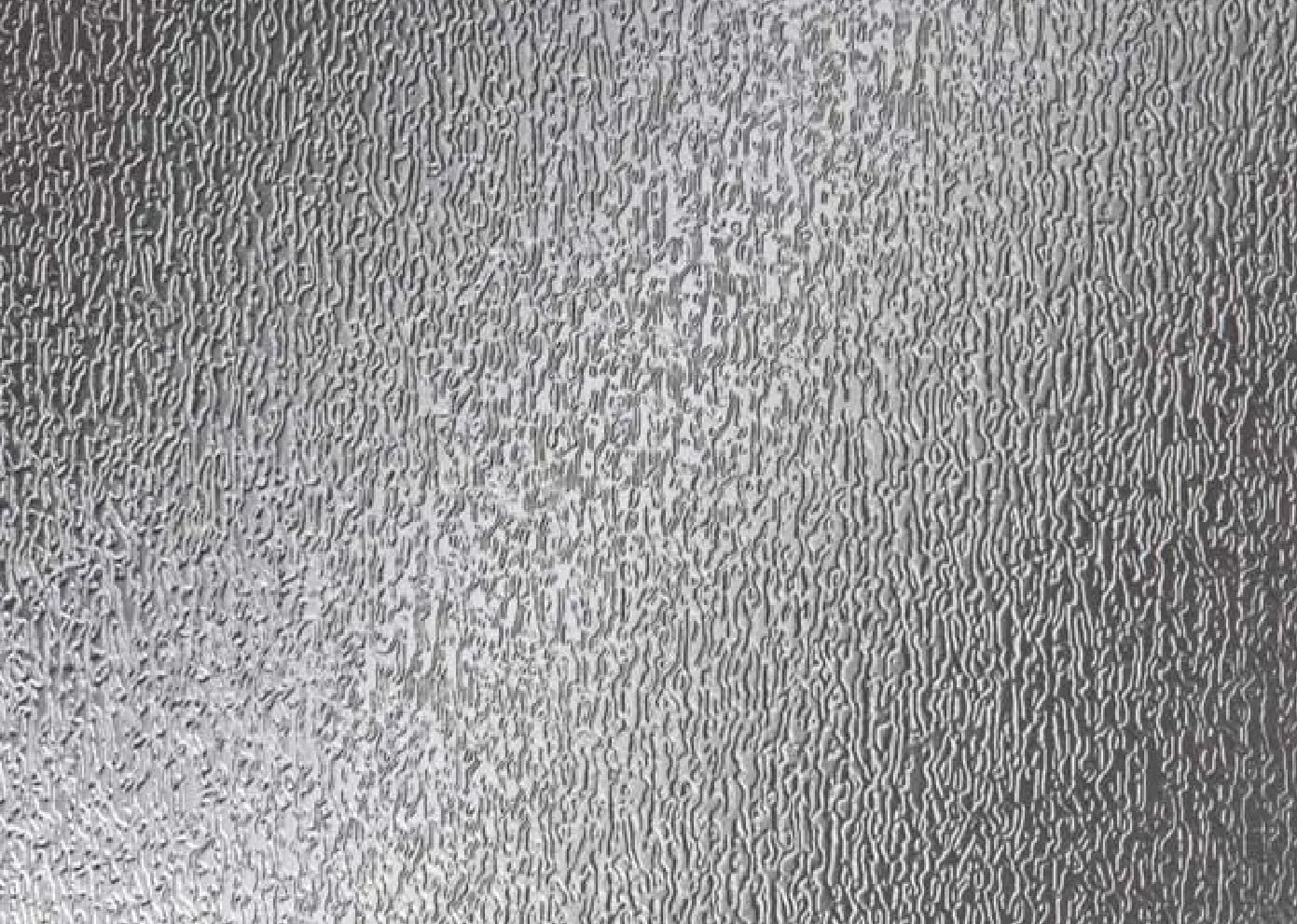 A close up of the silver surface of a metal sheet.