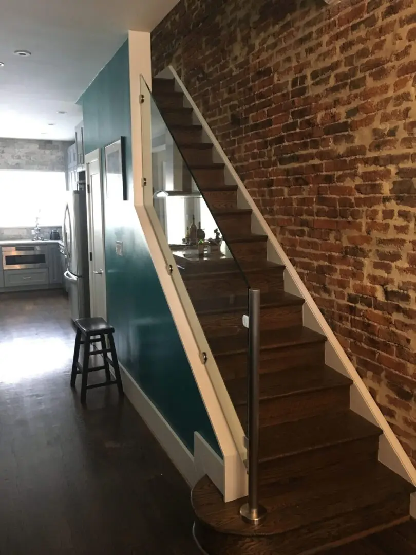 A room with stairs and brick walls