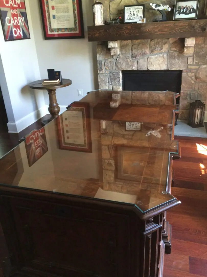 A glass table with a wooden top in the middle of a room.